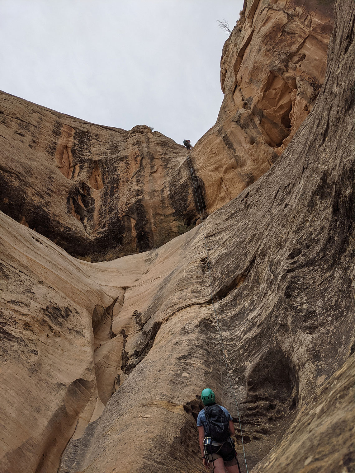 Belaying at the bottom of rappel 2 in Wonderland Canyon