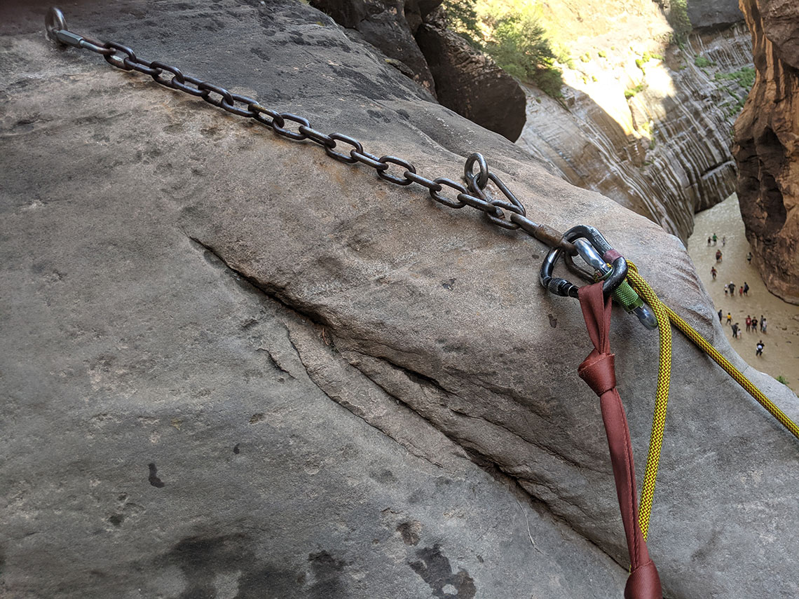 Glued-in chains supply an anchor for the final rappel in Mystery Canyon