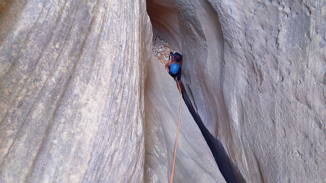 Squeezing down the tight 9th rappel in Englestead