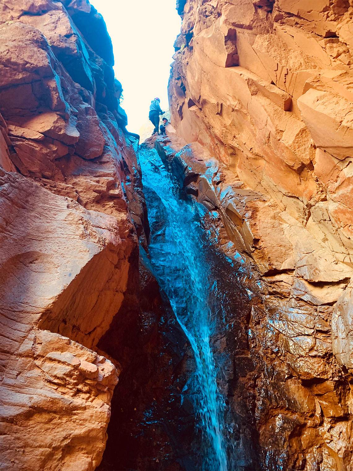 Person starting the 3rd rappel in Benson Creek slot canyon