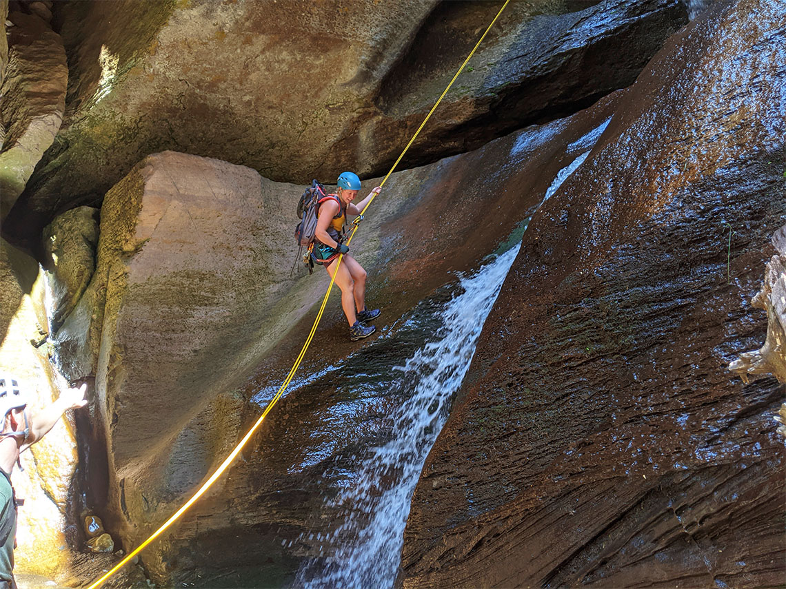 Descending the last rappel in Pleiades Canyon