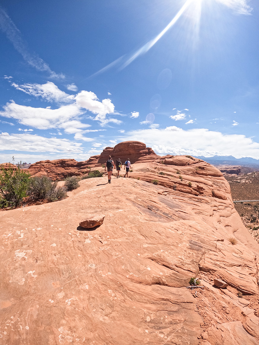 Walking along the ridge of U-Turn Canyon in Arches National Park