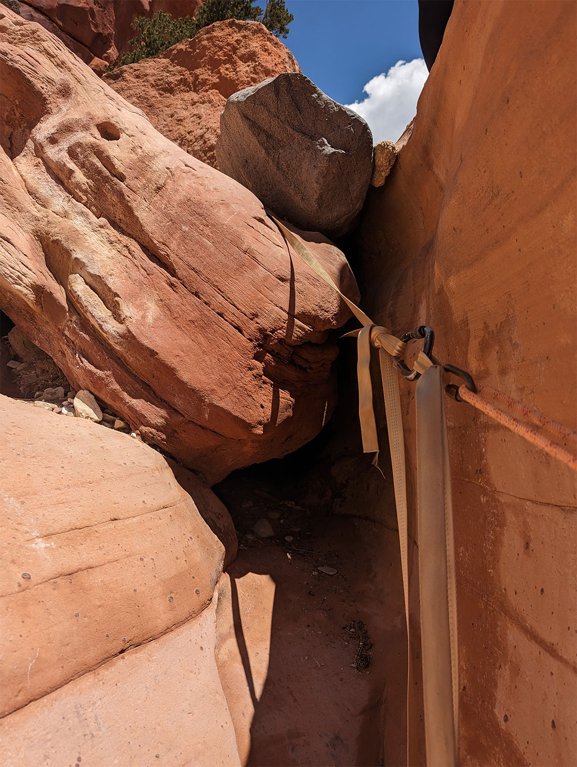 Showing the courtesy rigging on the anchor of the first rappel in Sunglow Canyon