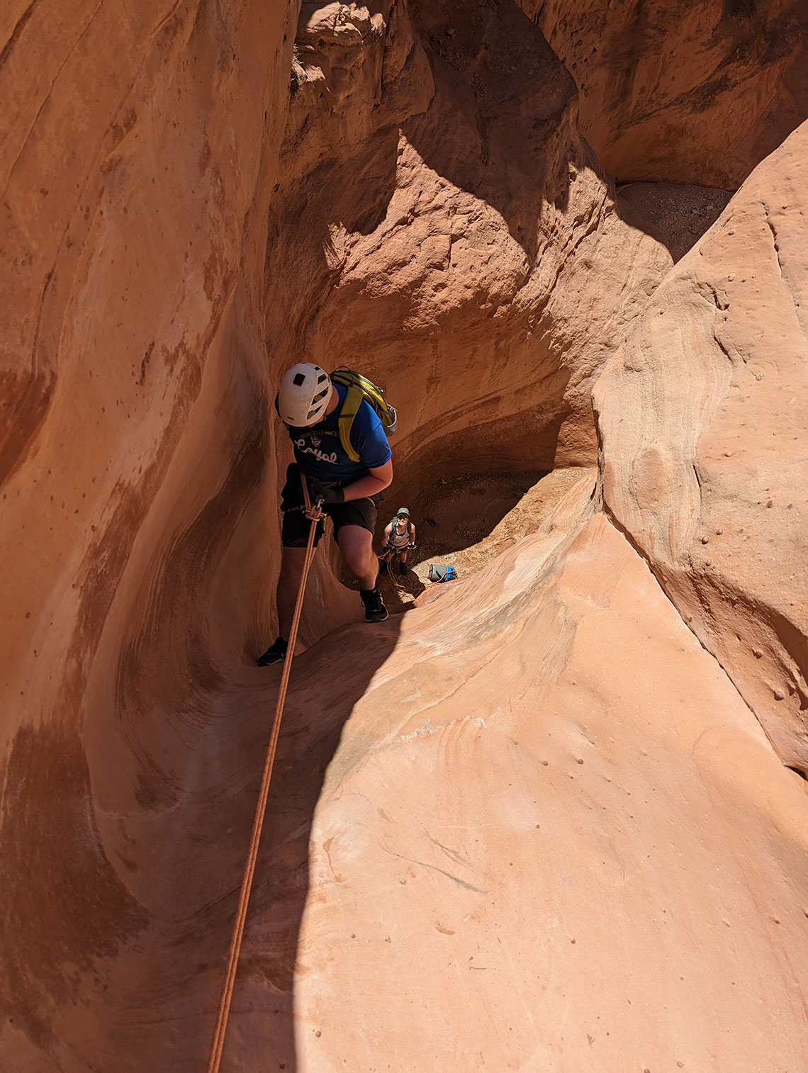 Rappelling down the first drop into the slot in Sunglow Canyon